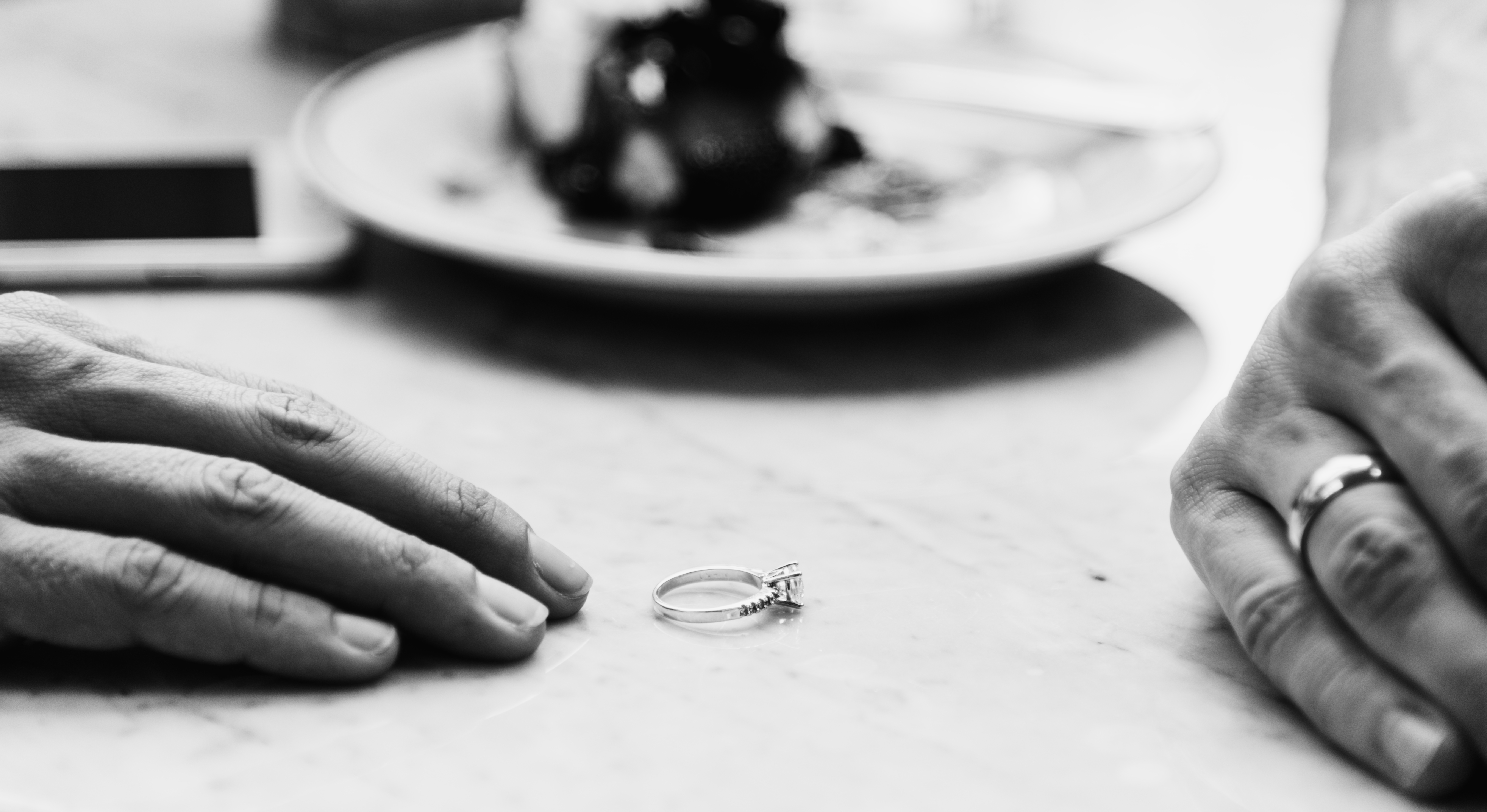 An engagement ring is prominent between two individuals, hinting at a significant conversation about their future together amid trust issues indicating a Post Matrimonial Investigation in Pune.
